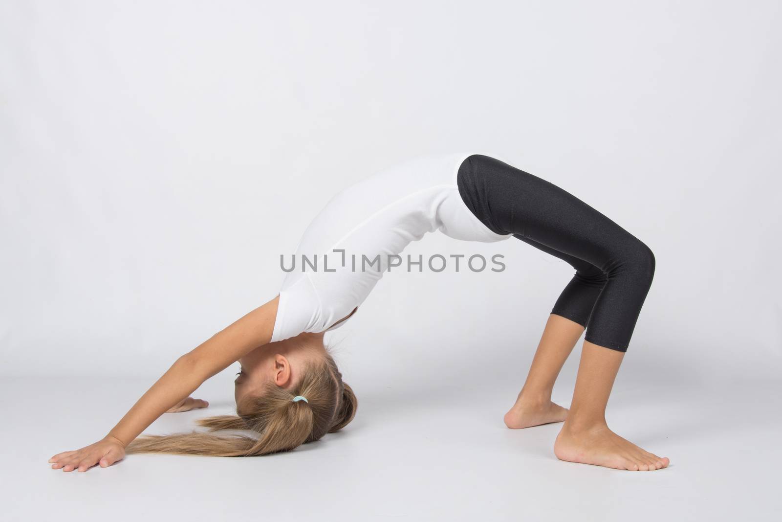 six year old girl aspiring gymnast performs a number of training exercises