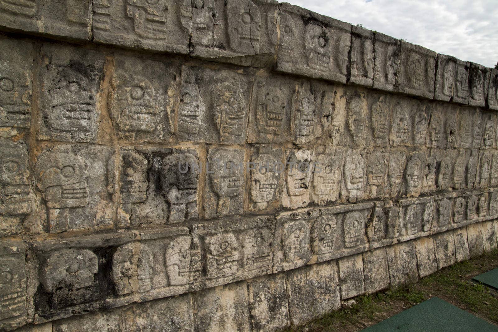 Mayan wall of carved stone skulls, Chichen Itza, Mexico