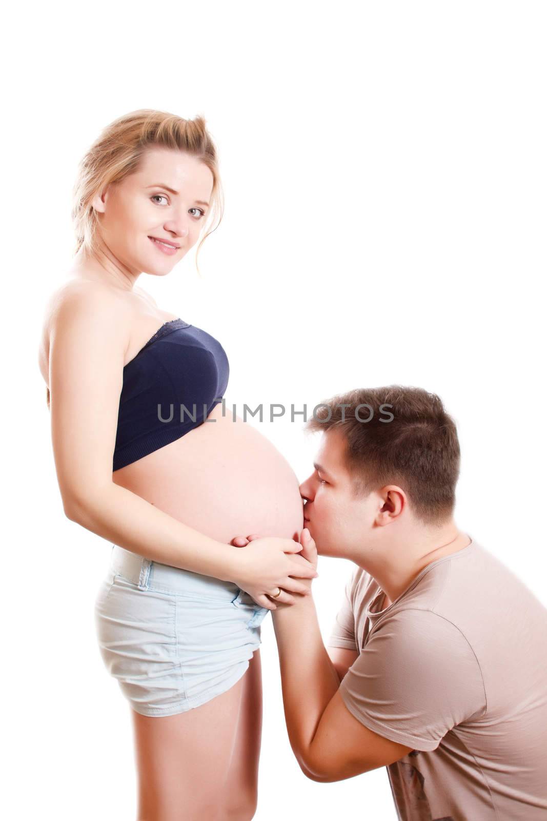 Man kissing pregnant woman isolated on white background