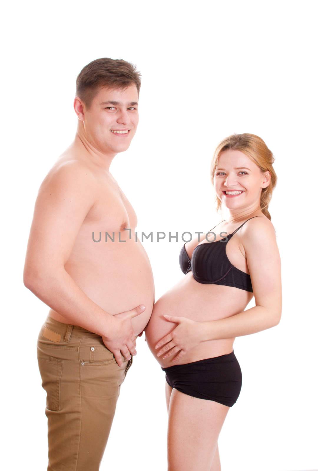 Pregnant woman and heavy man displaying their bare stomachs, caucasian/white.