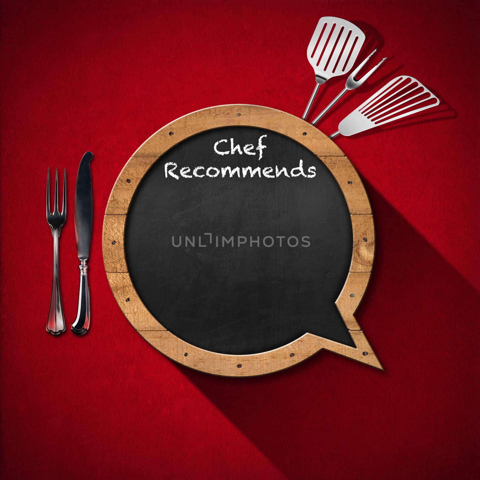 Blackboard in the shape of speech bubble with text Chef Recommends with kitchen utensils on a red velvet background