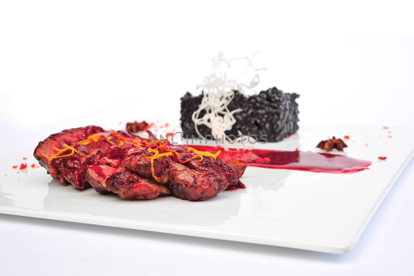 Sliced medium rare grilled Steak Ribeye served on white plate