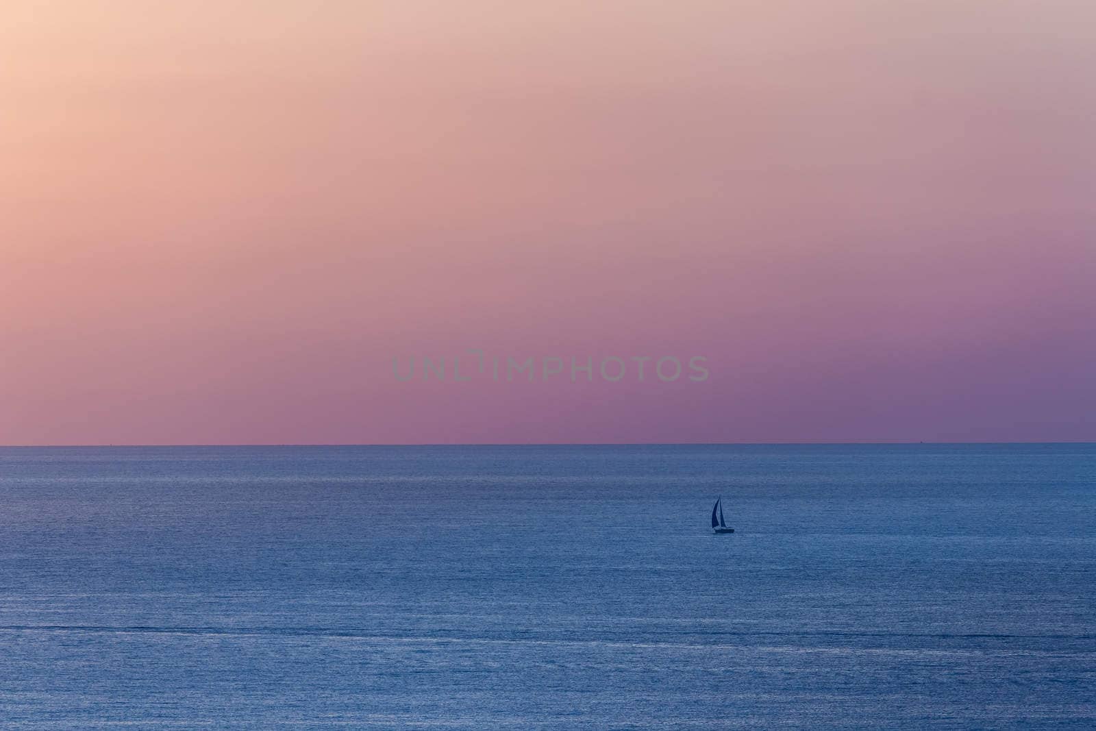 The boat on Mediterranean sea at sunset