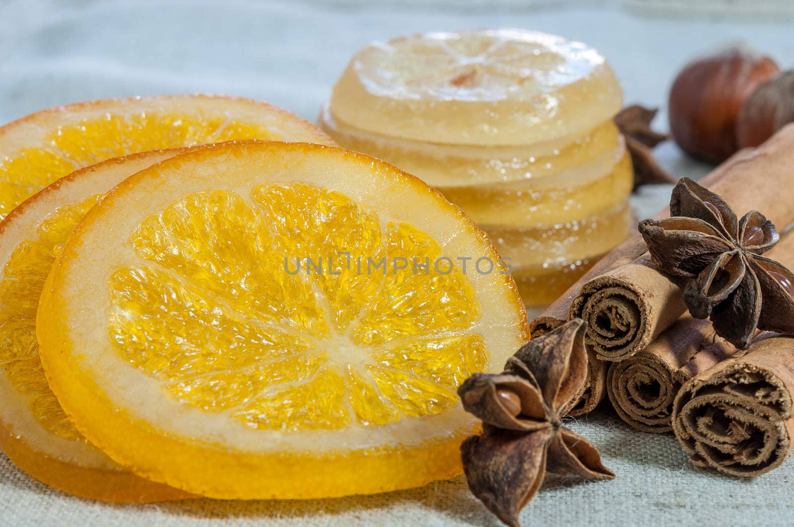 Orange slices and dried lemons decorated with cinnamon and hazelnuts