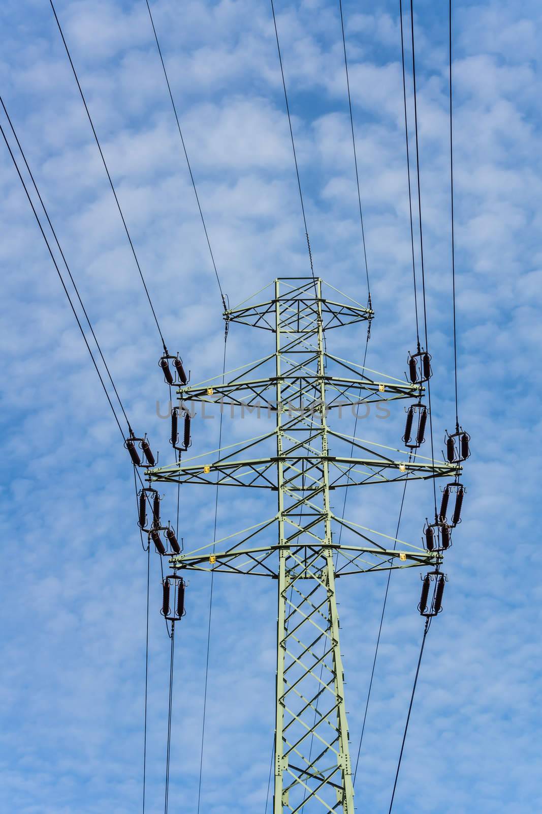 Electricity pylon at the cloudy sky.