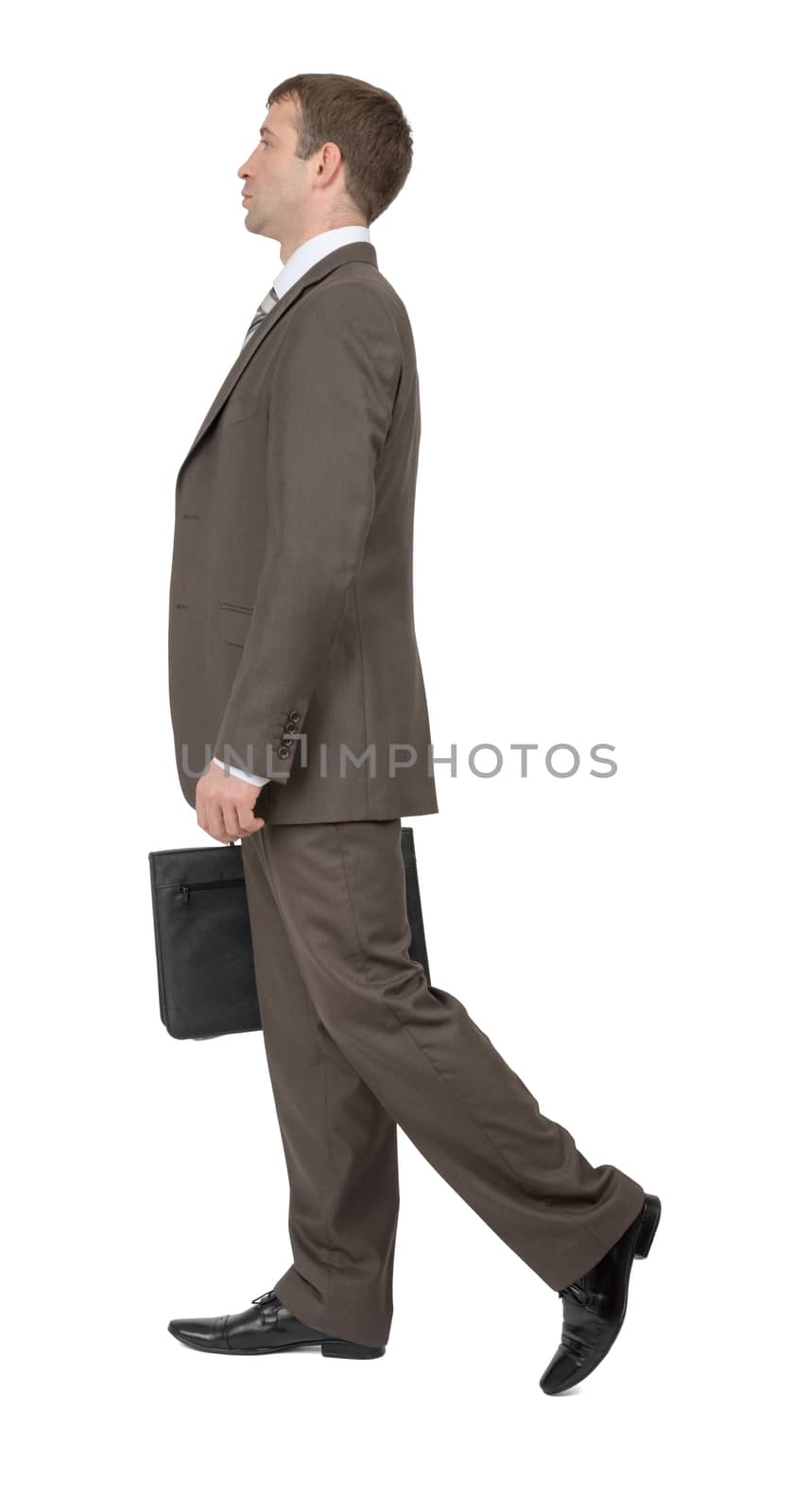 Businessman walking on isolated white background, side view