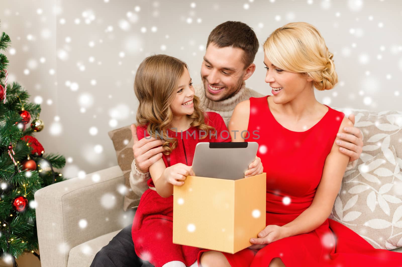 smiling family taking tablet pc out from gift box by dolgachov