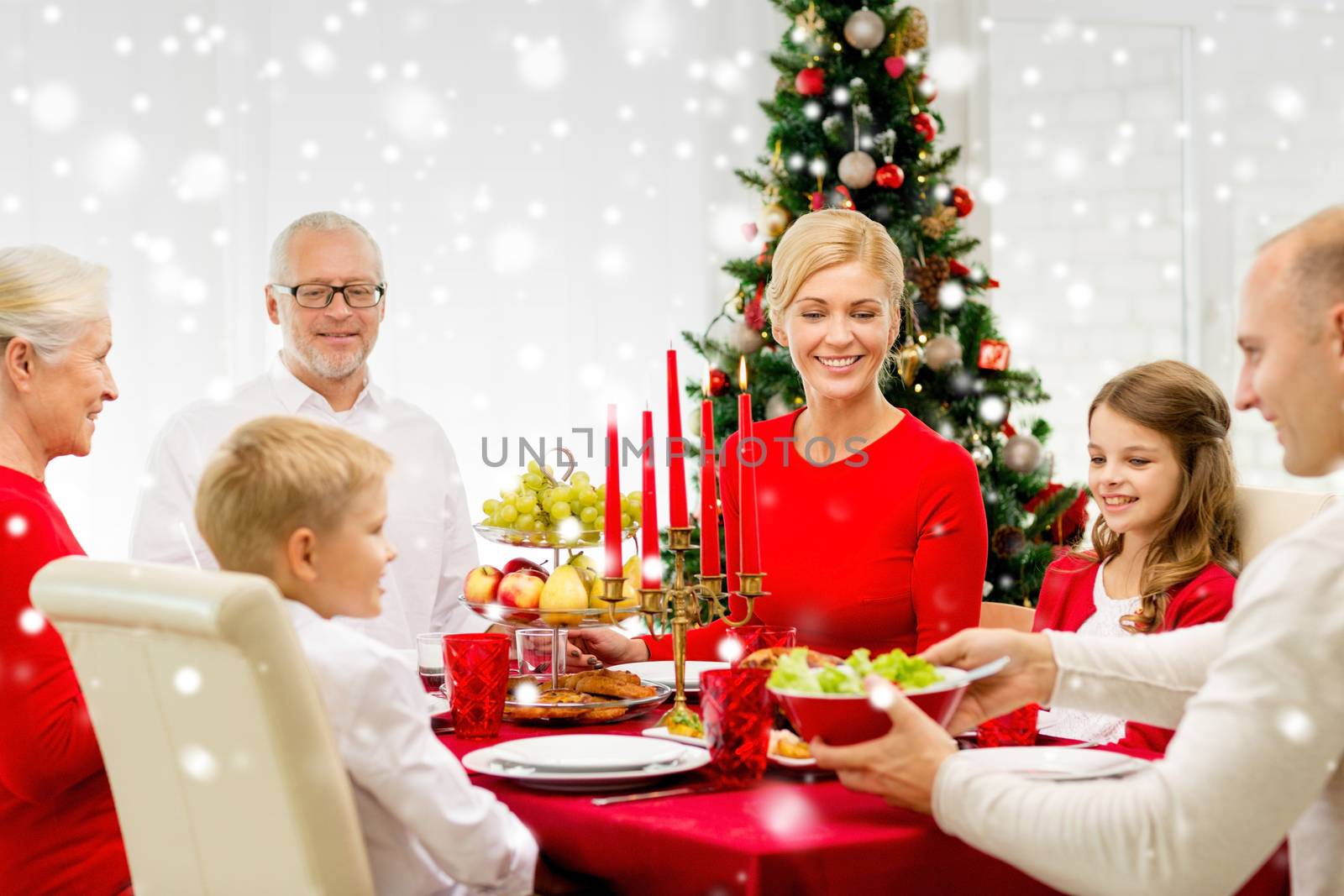 smiling family having holiday dinner at home by dolgachov