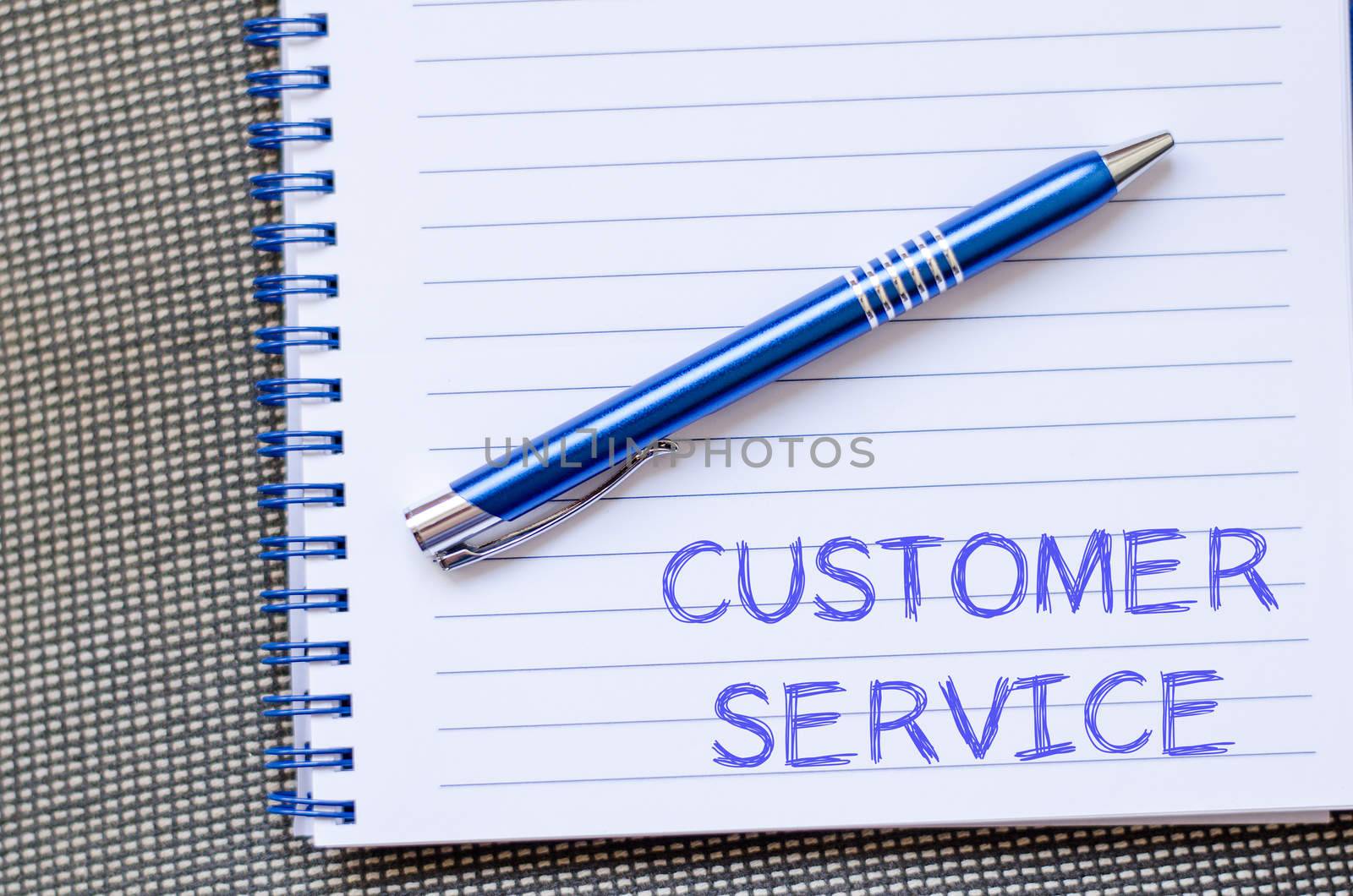 Customer service text concept write on notebook with pen