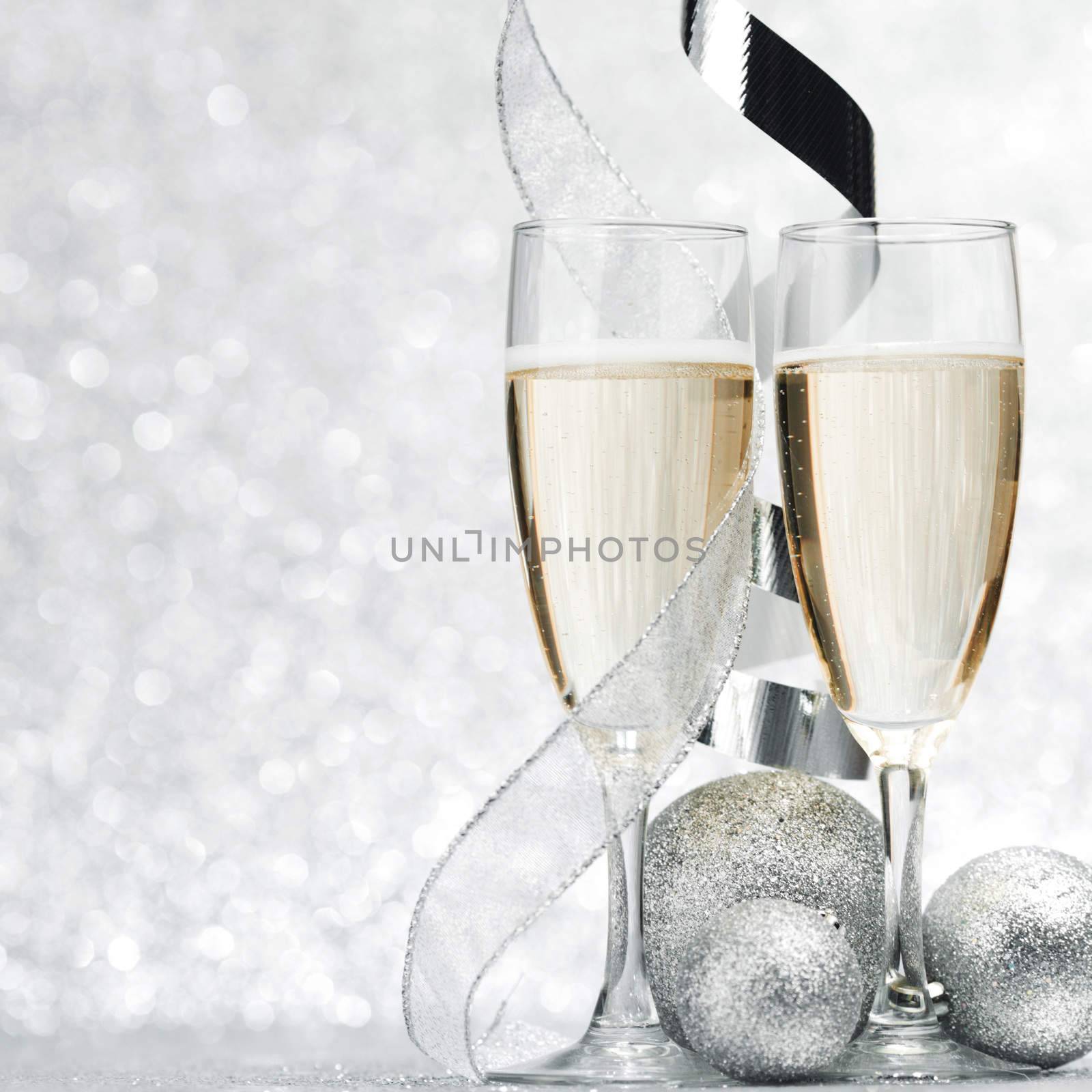 Champagne and new year decor on silver bokeh background