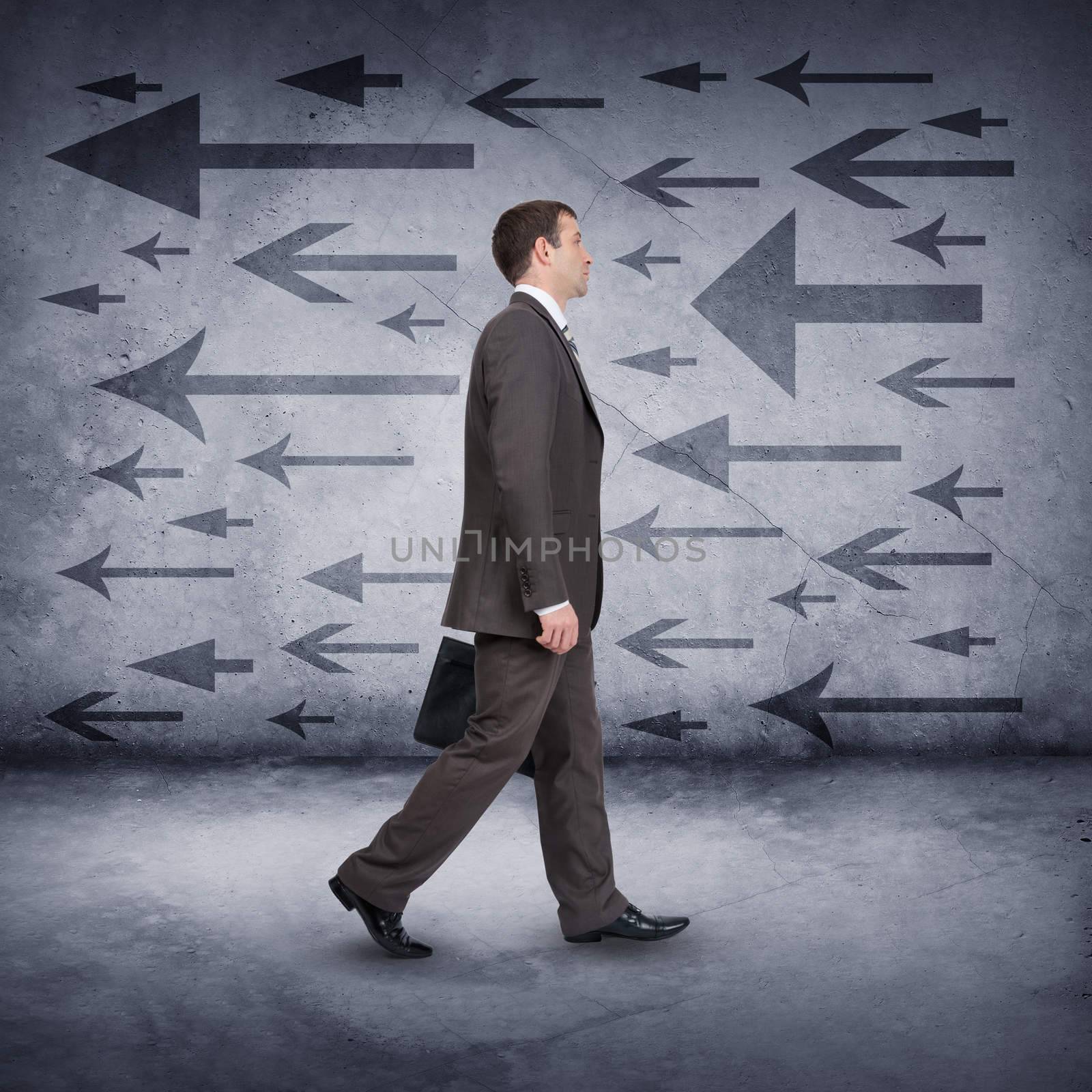 Businessman walking on abstract background with arrows