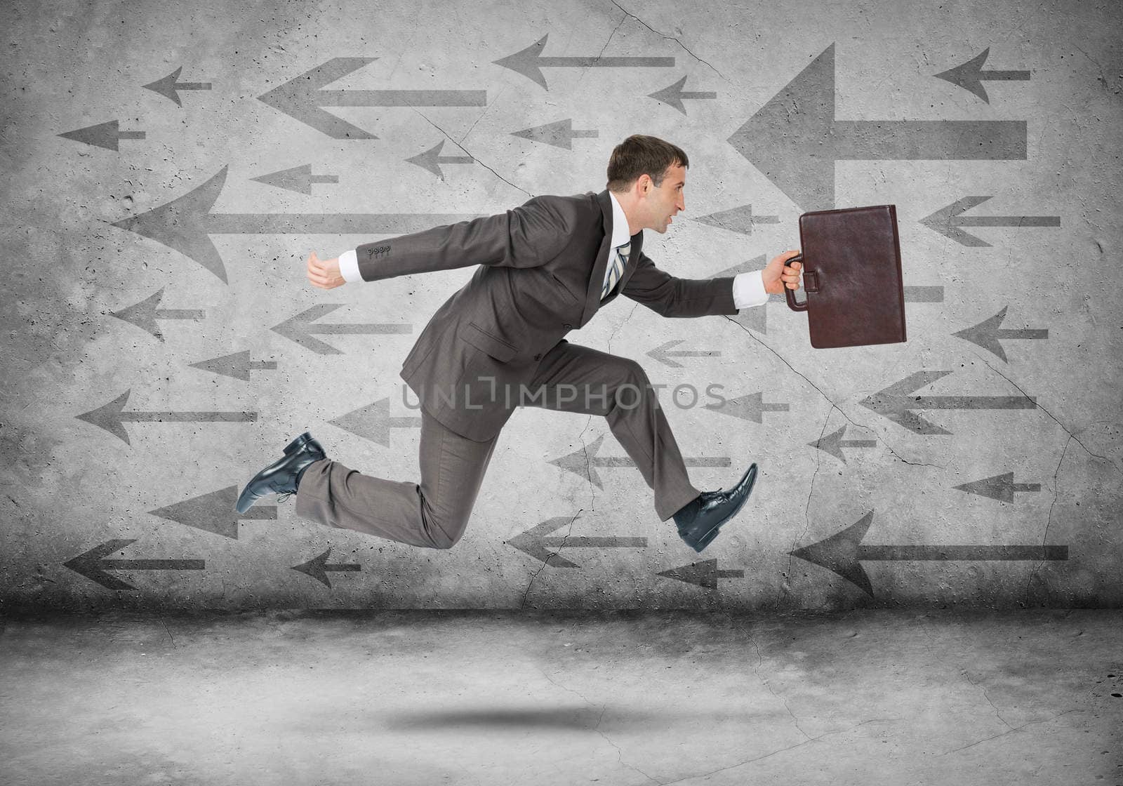 Businessman running fast on abstract background with arrows