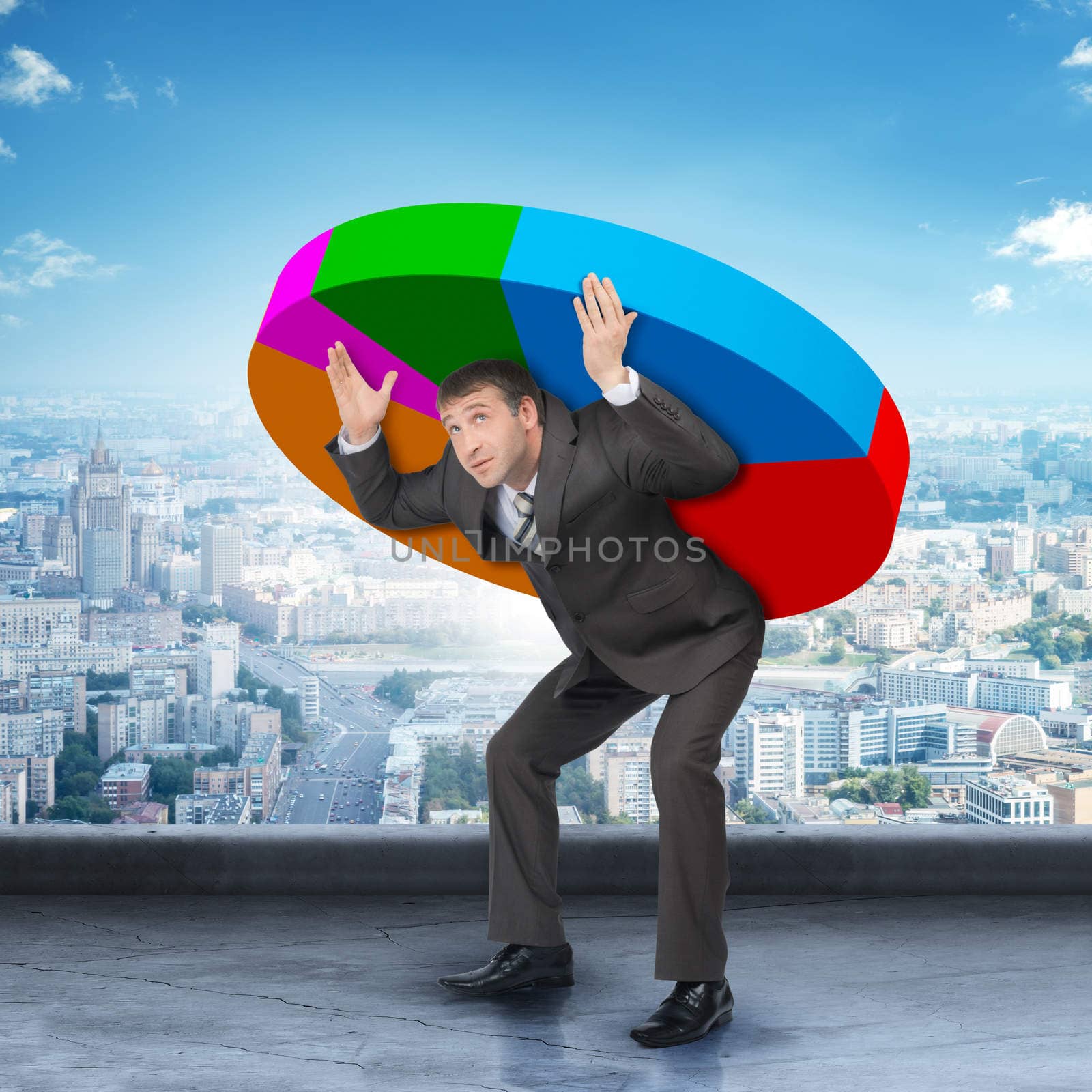 Businessman in suit holding heavy colorful diagram