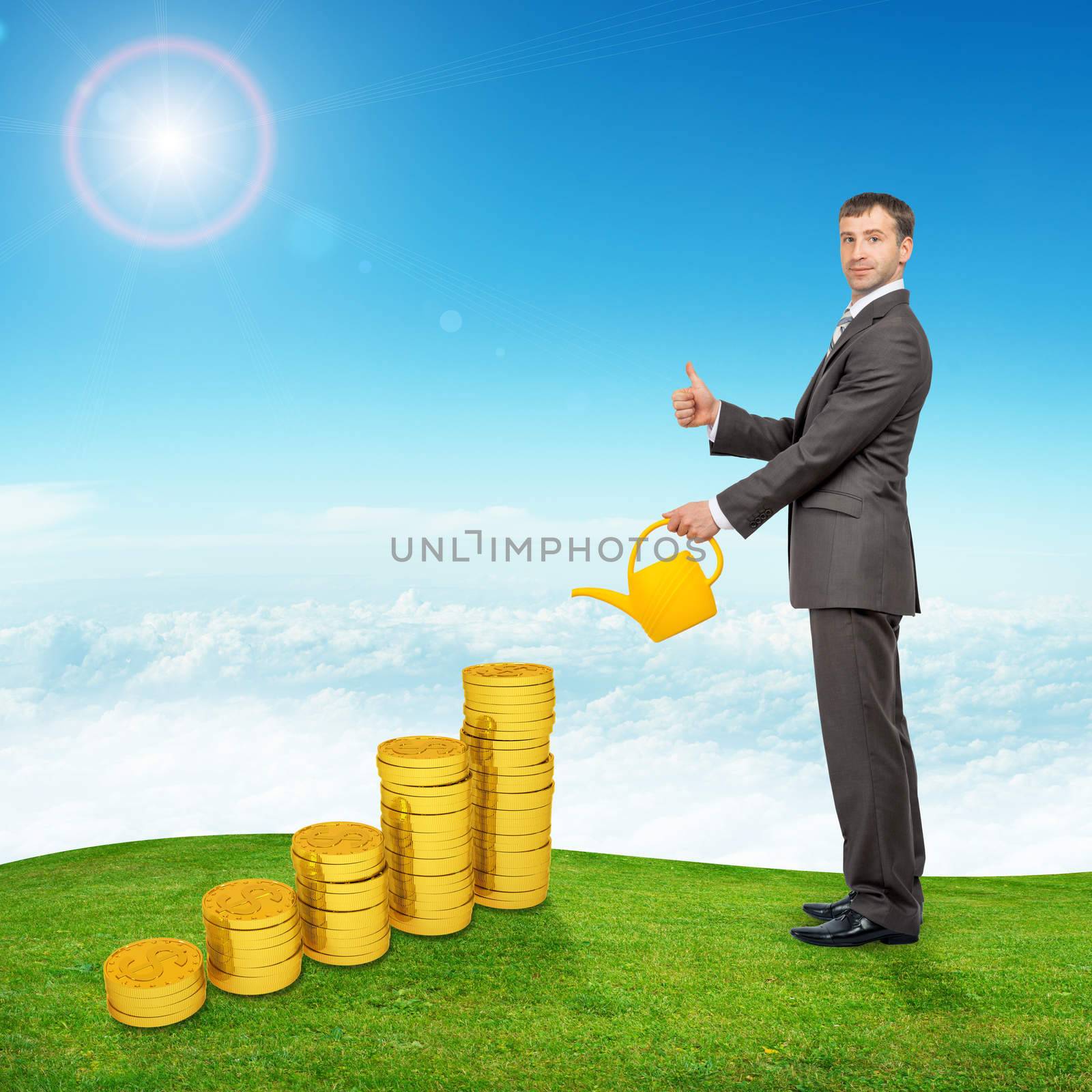 Businessman with yellow watering-can showing sign ok