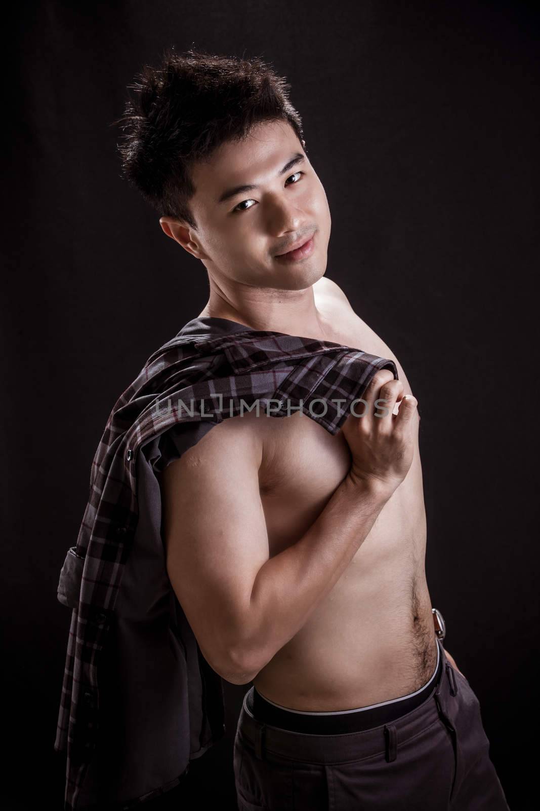 Portrait of Asian young man on black background -topless handsome young man