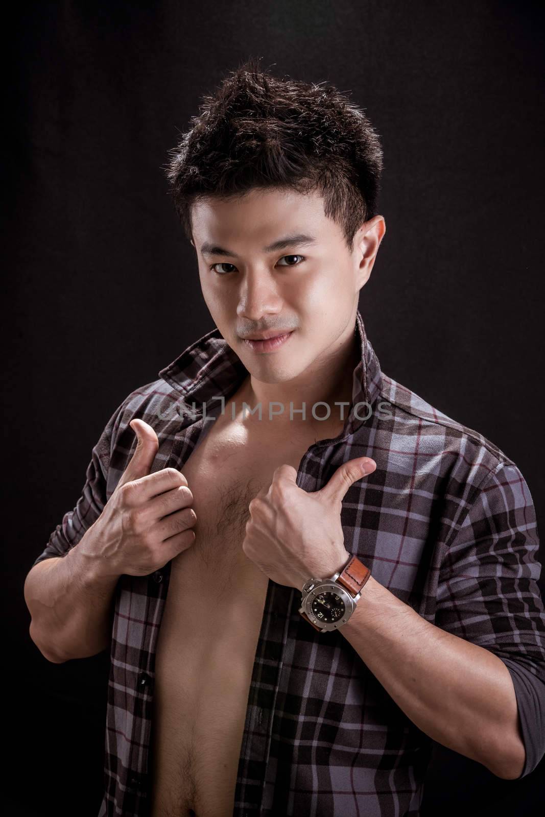 Portrait of Asian young man on black background -smily handsome young man