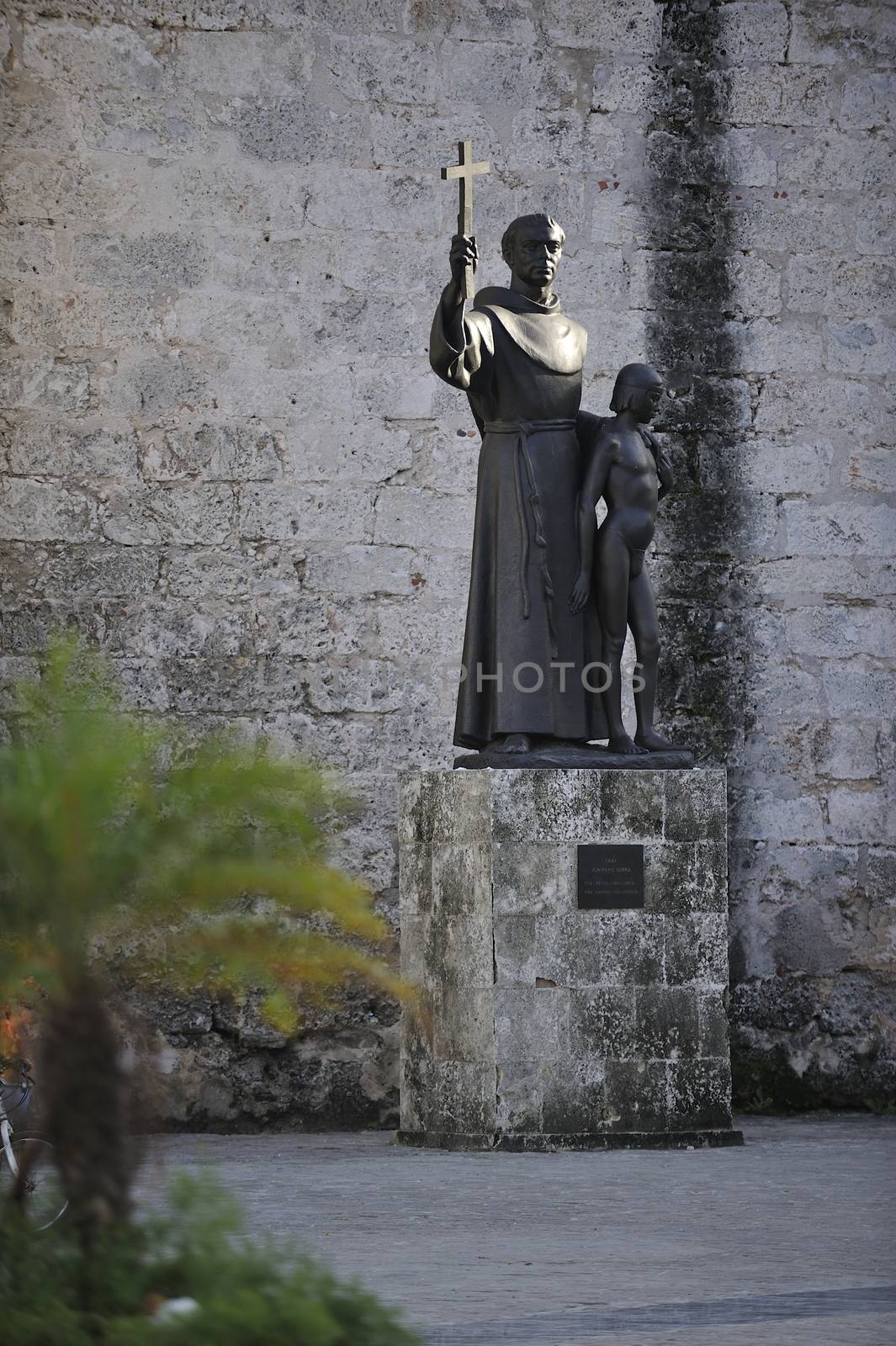 Havana, Cuba, August 2013.  Statue of St Francis of Assisi and small boy, Plaza de San Francisco in Old Habana.