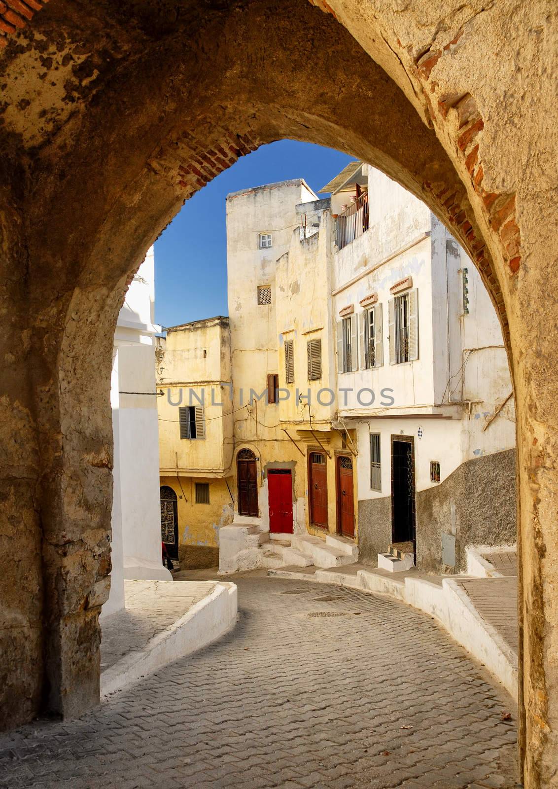 View to a narrow street through the city gate in Tangier, Morocco