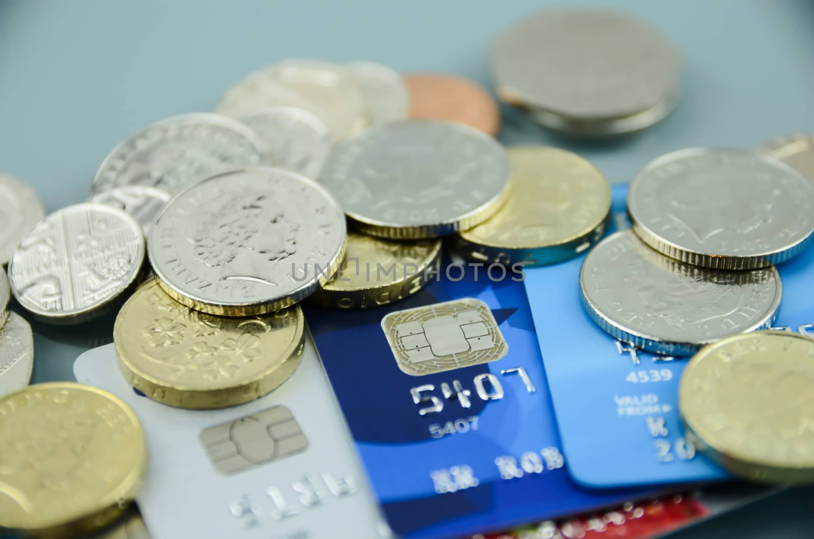 Credit cards closeup with money, coins
