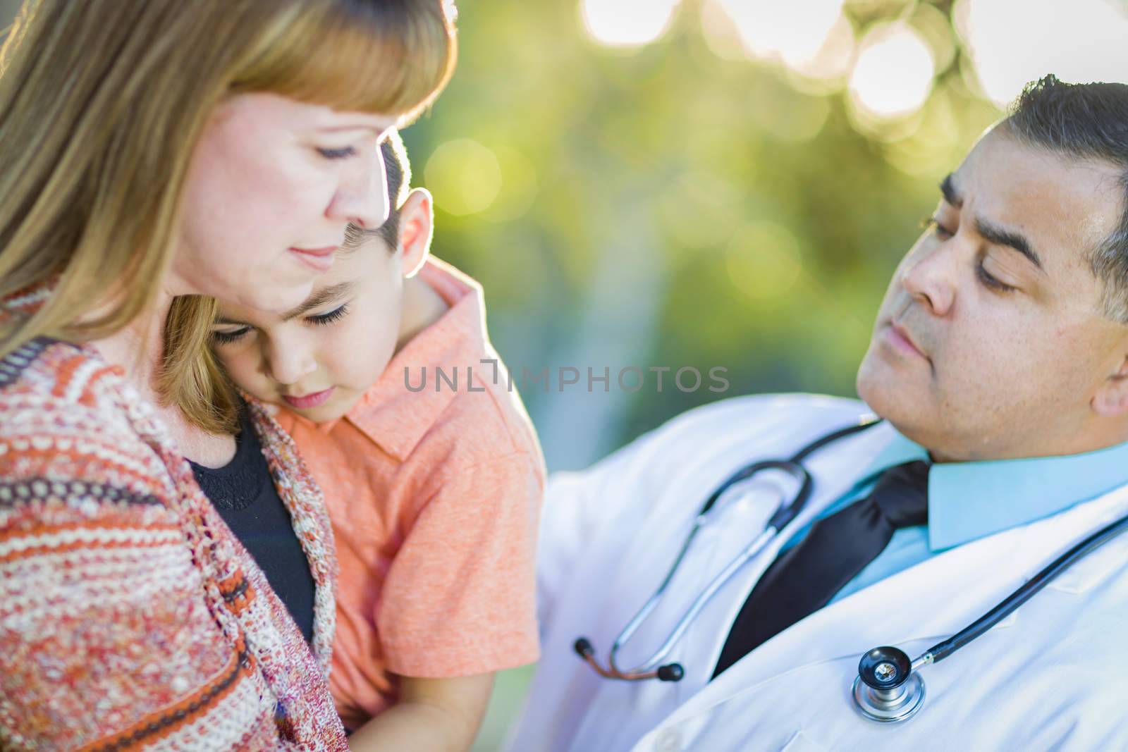 Sick Mixed Race Boy, His Mother and Hispanic Doctor Outdoors.