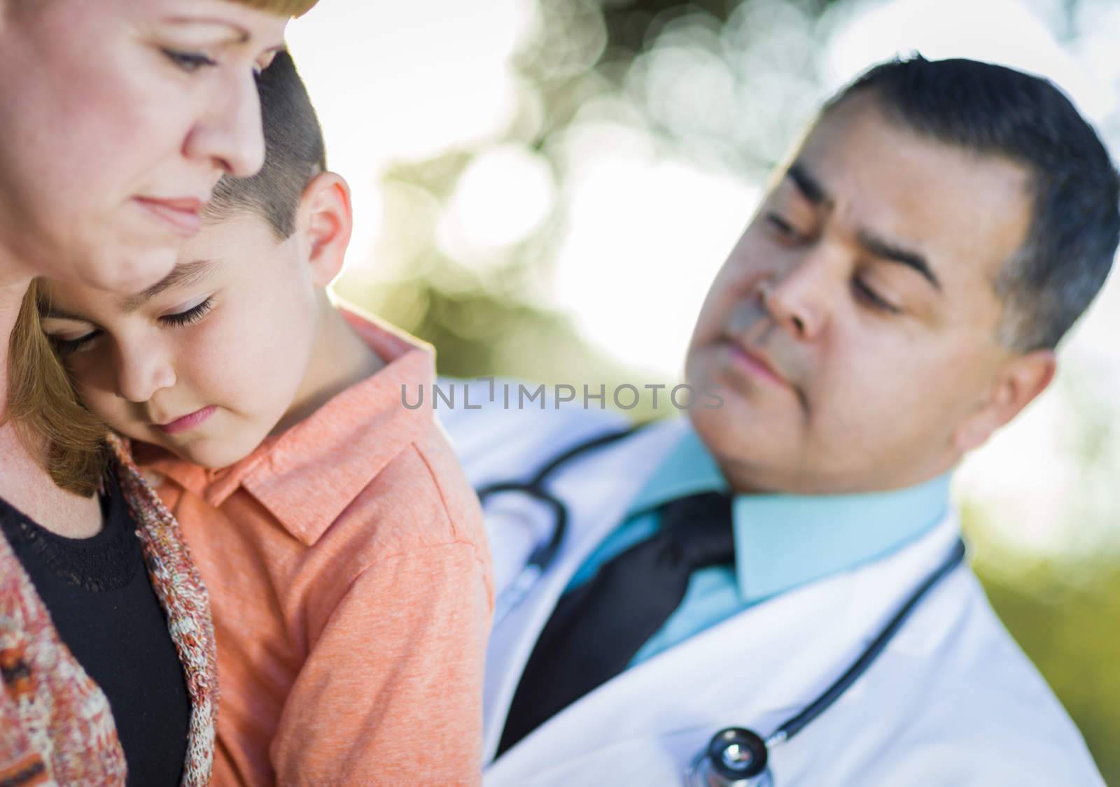 Sick Mixed Race Boy, His Mother and Hispanic Doctor Outdoors.