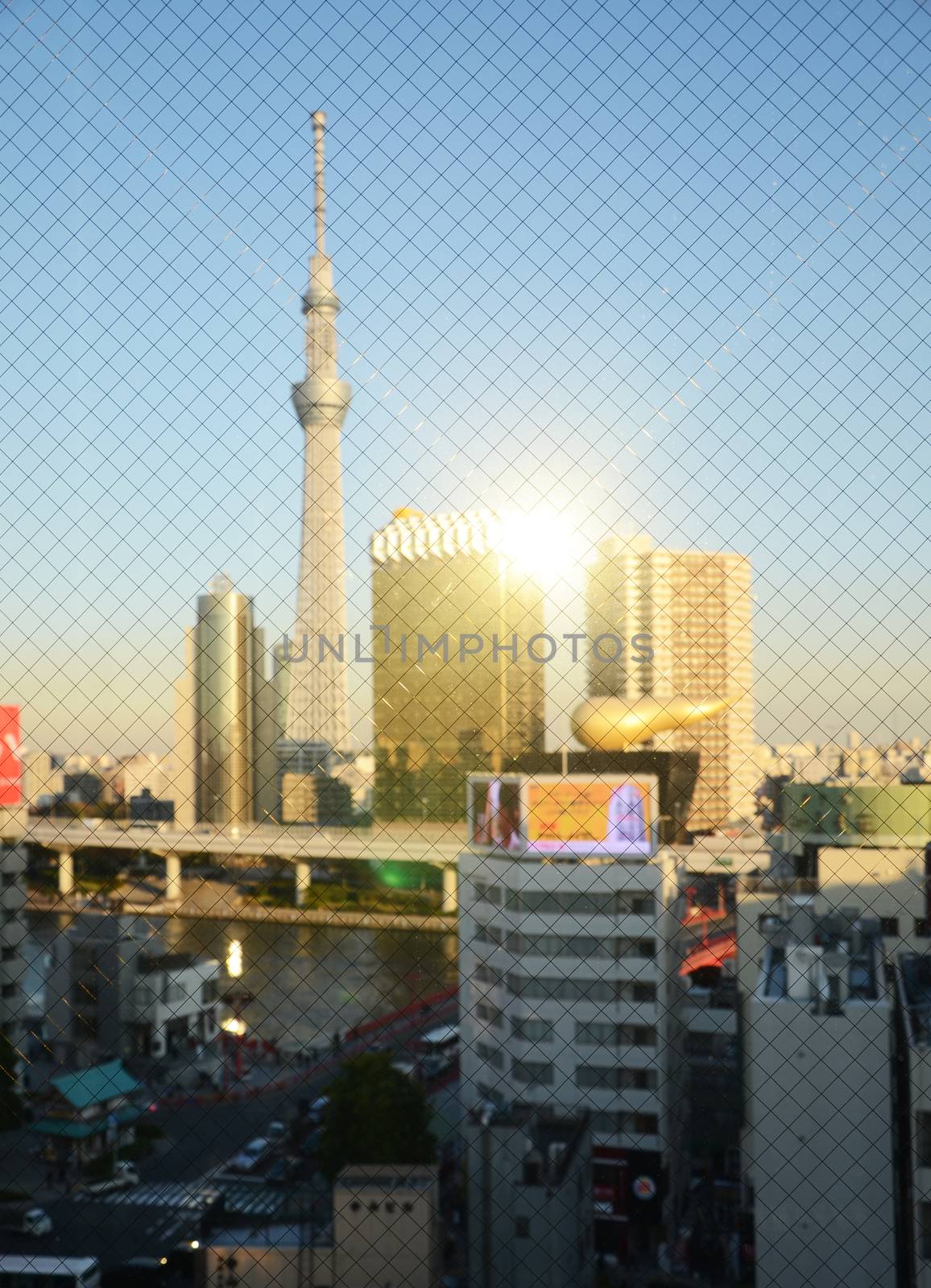 Tokyo Sky tree building at sunset through wired glass in Tokyo, Japan. Blurred background