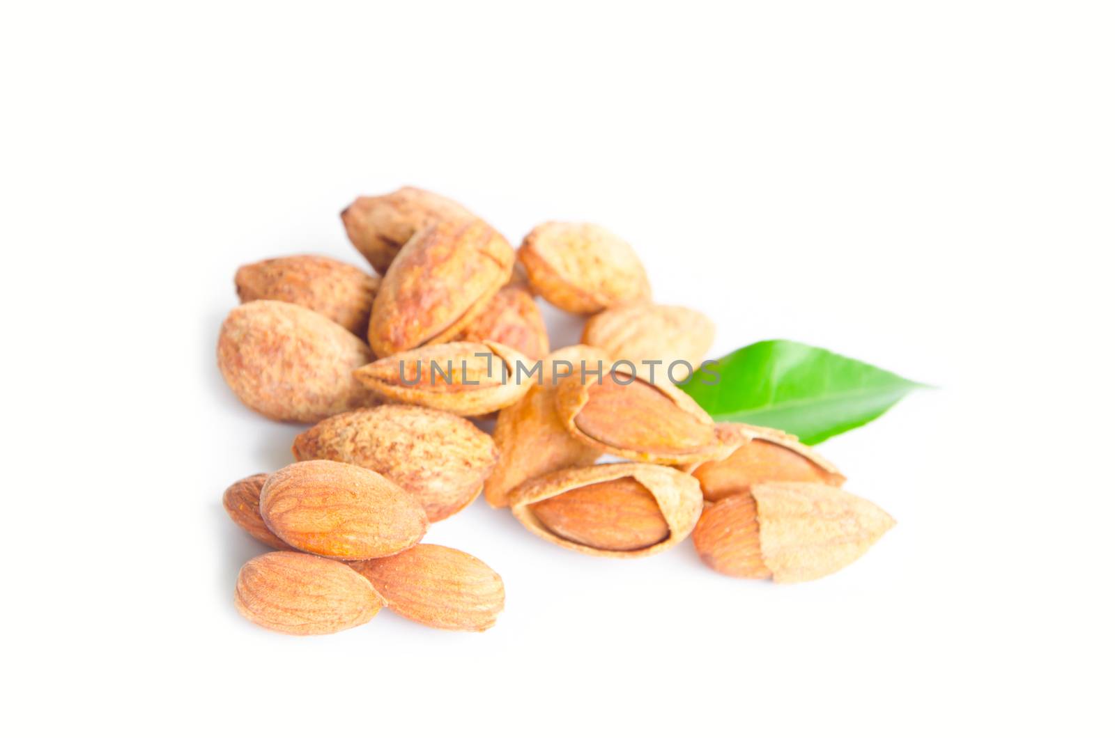 Almond with leaves isolated on white background