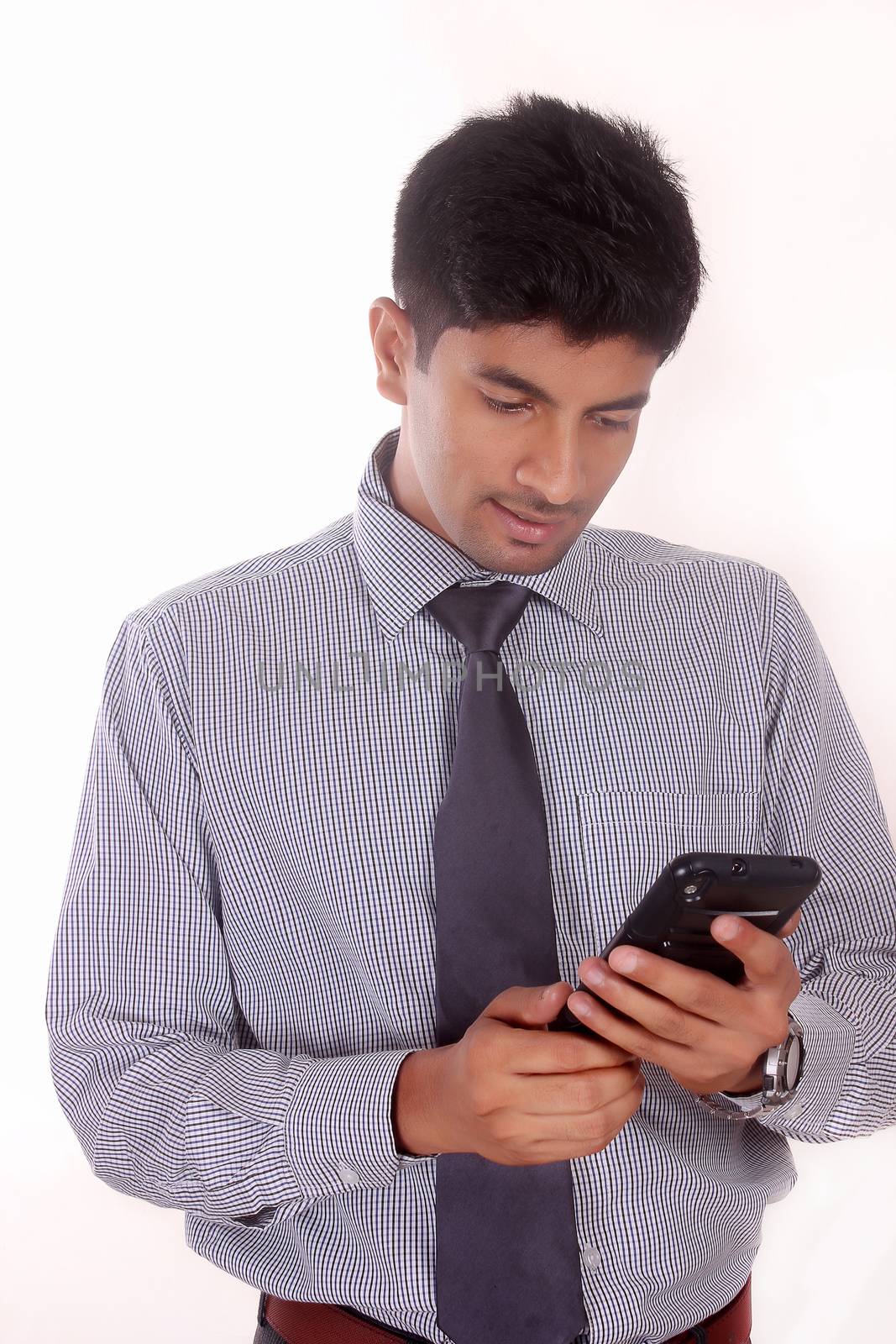 Businessman texting with his cellphone against a white background