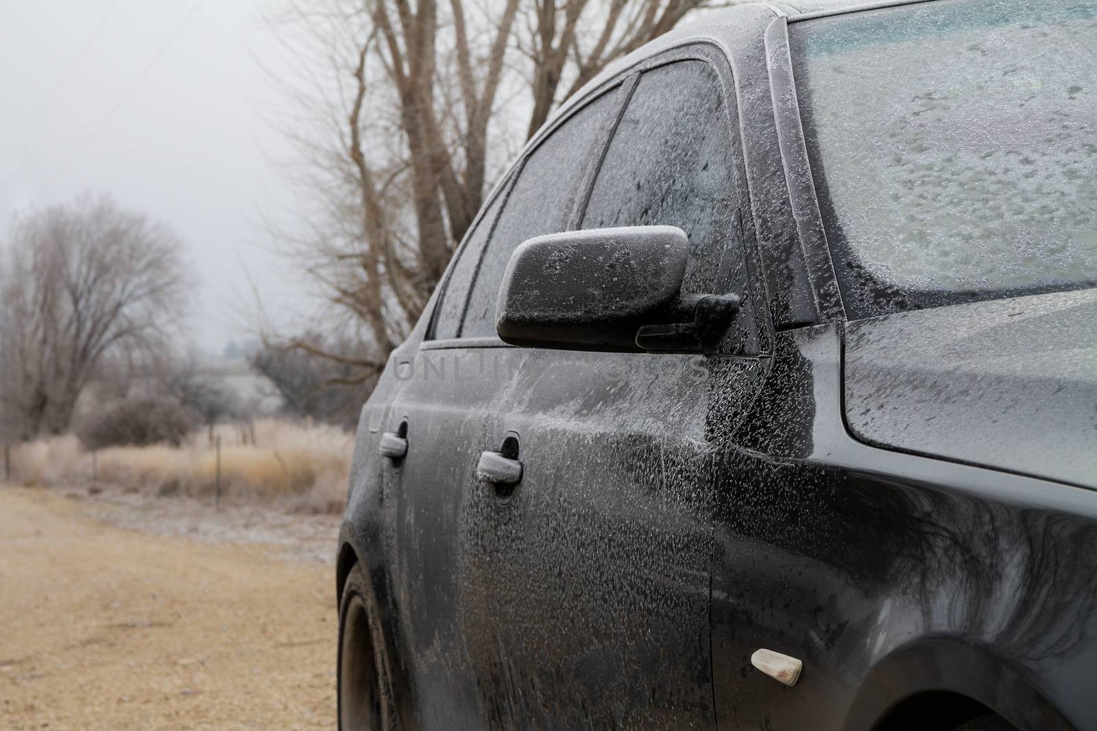 Black luxury car sitting at home frozen