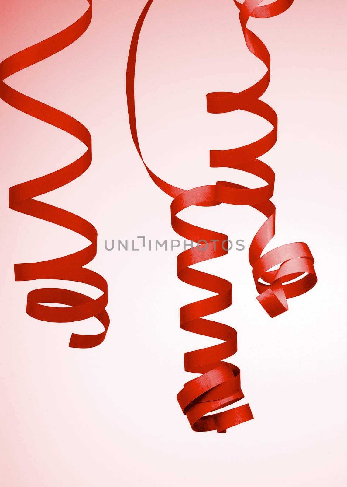 Three Red Curled Party Streamers isolated on Toned background
