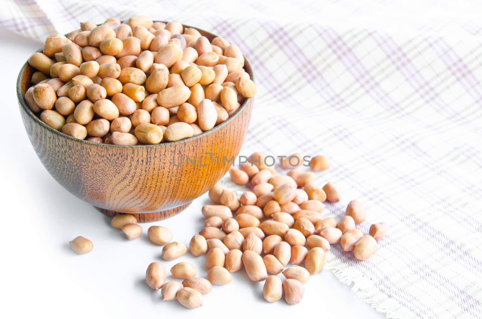 Groundnuts in wooden cup on the table.
