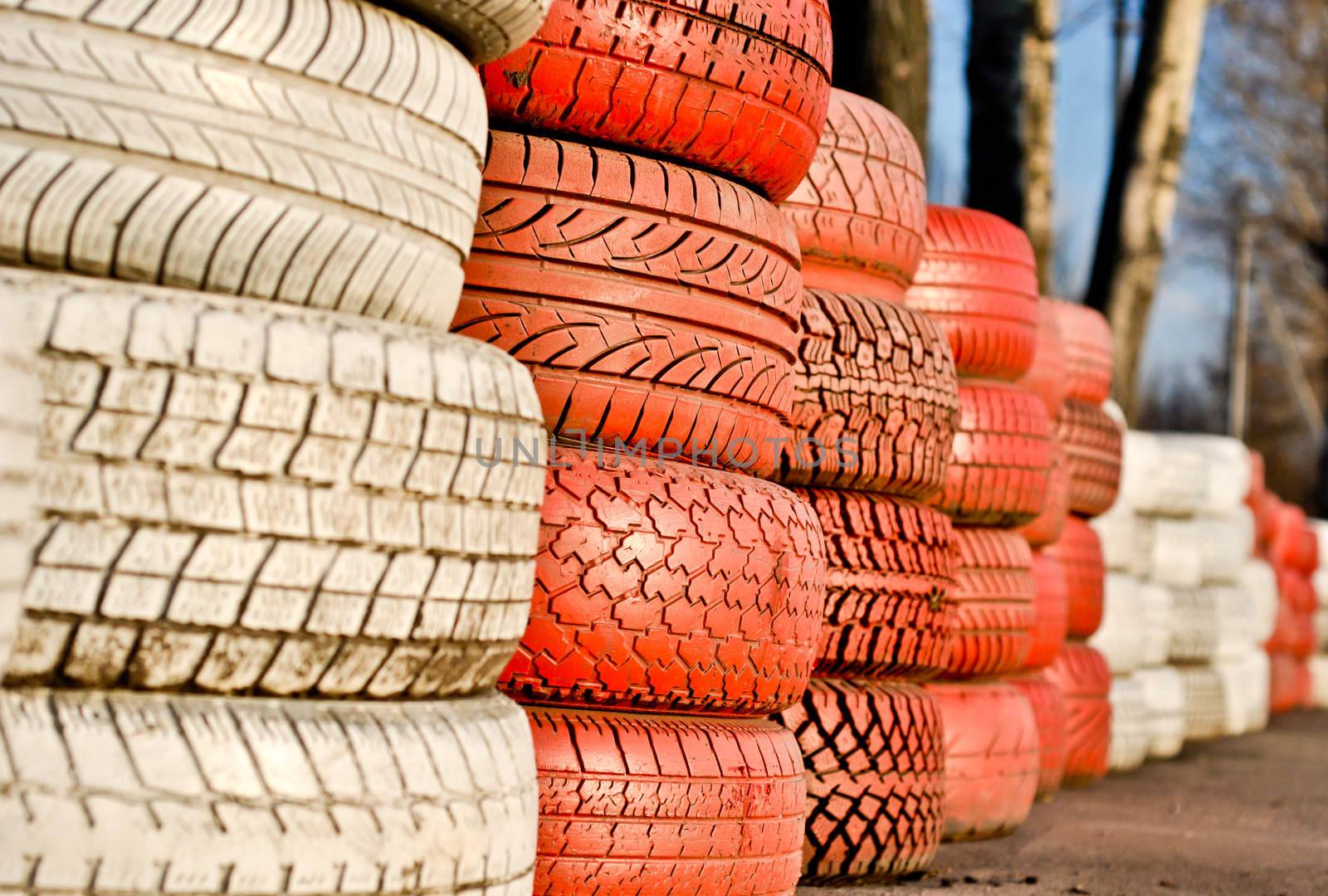 racetrack fence of white and red of old tires