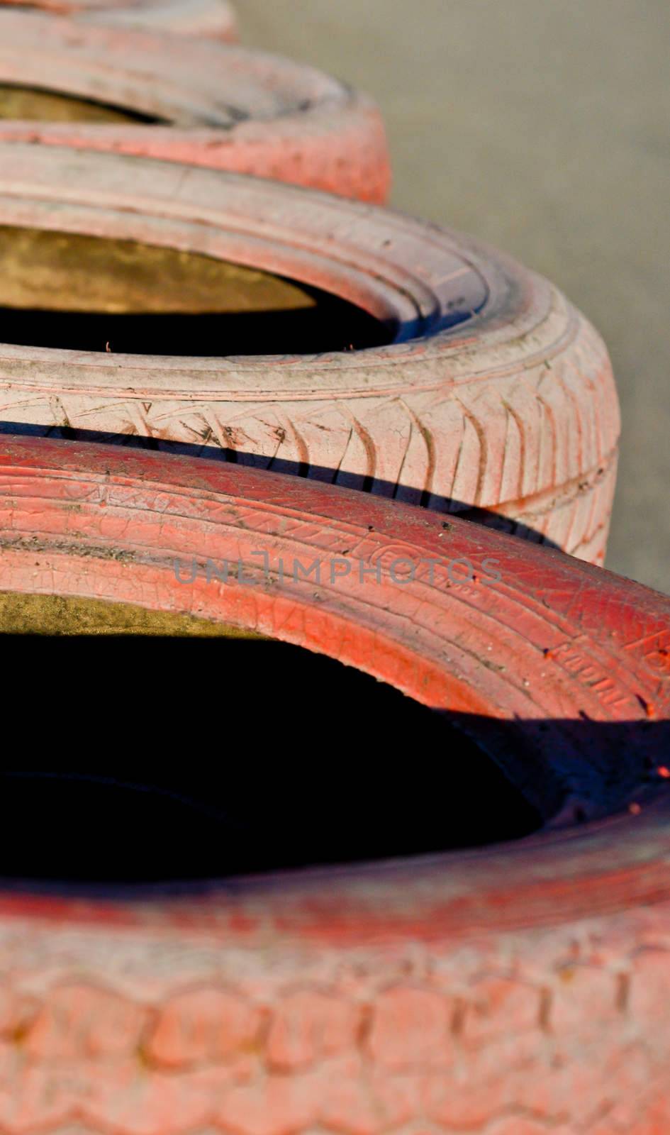 close up of racetrack fence of  red  old tires by vlaru
