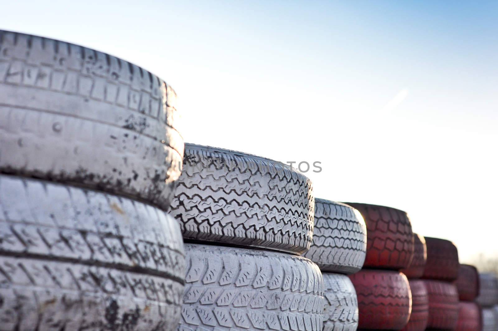 close up of racetrack fence of  red and white old tires