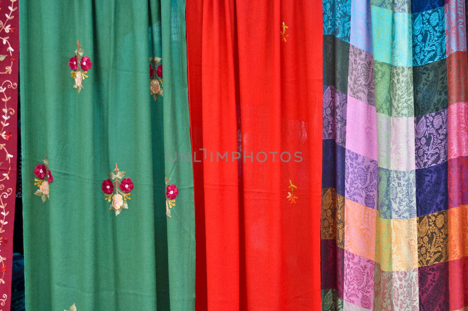 colorful patterned fabrics hanging in a row