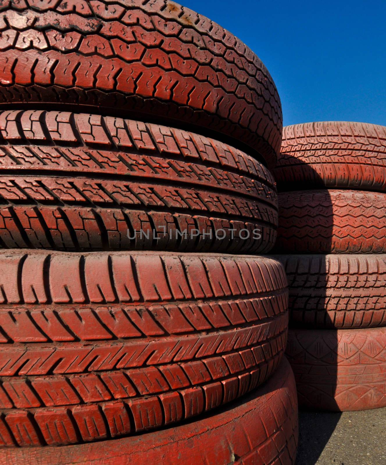 close up of racetrack fence of  red old tires by vlaru
