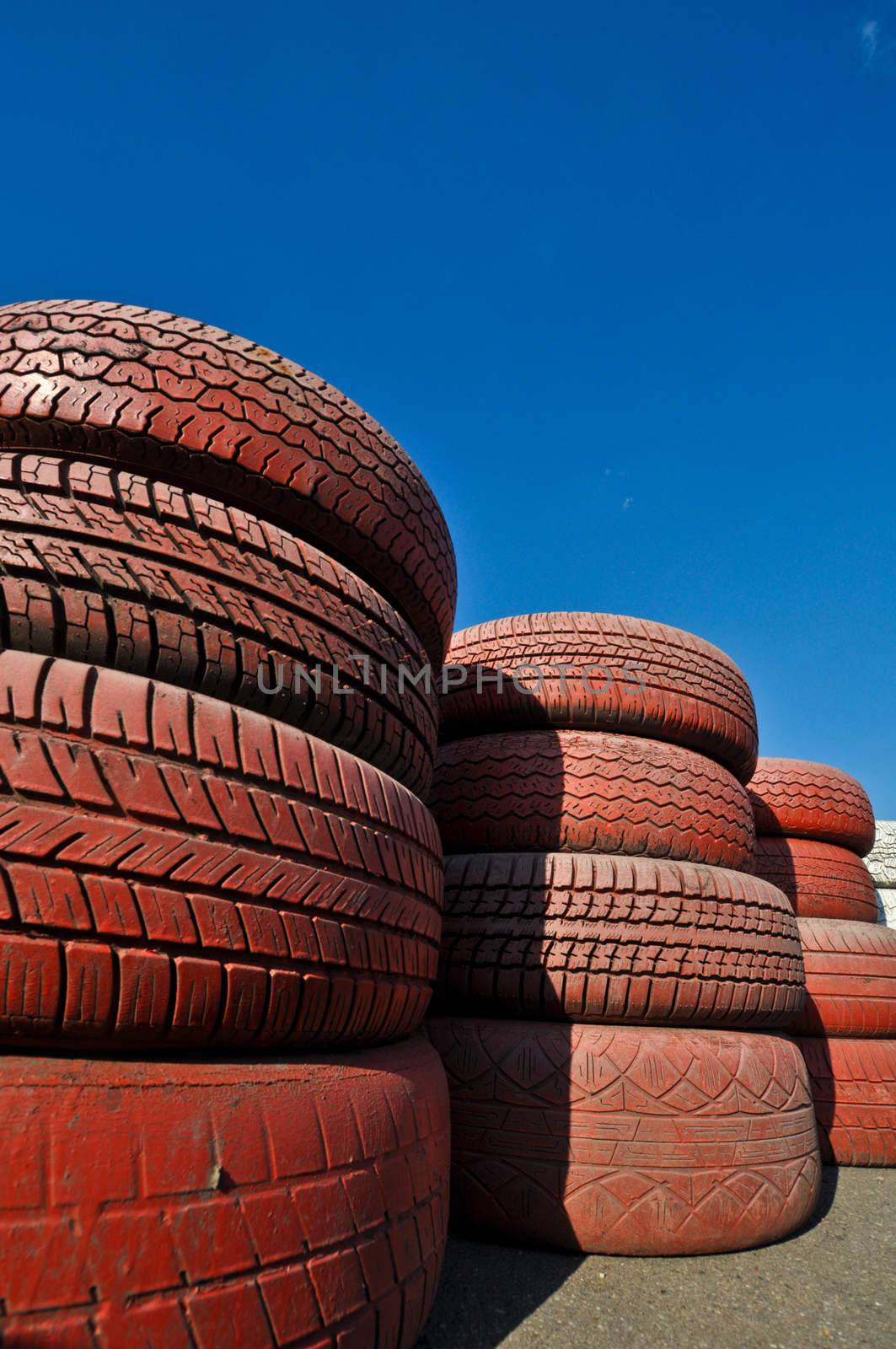 close up of racetrack fence of  red old tires by vlaru