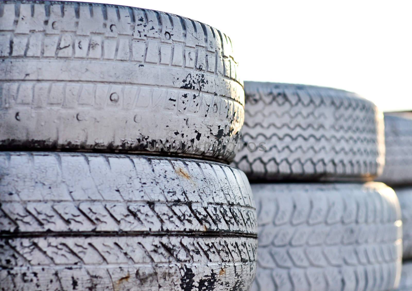 close up of racetrack fence of  white old tires