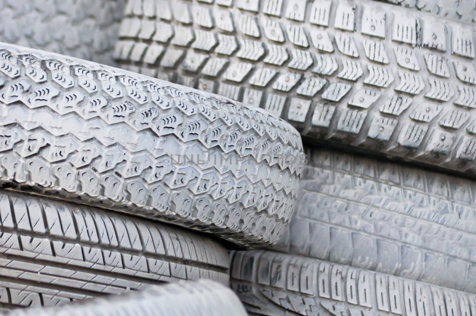 close-up. the white automobile tires dumped in a a big pile