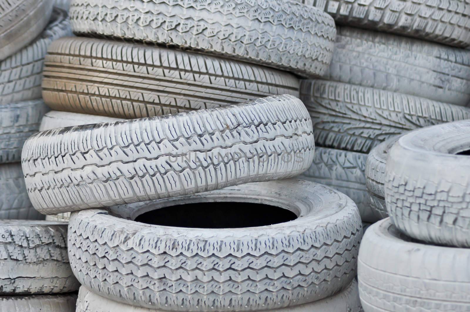 close-up. the white automobile tires dumped in a a big pile