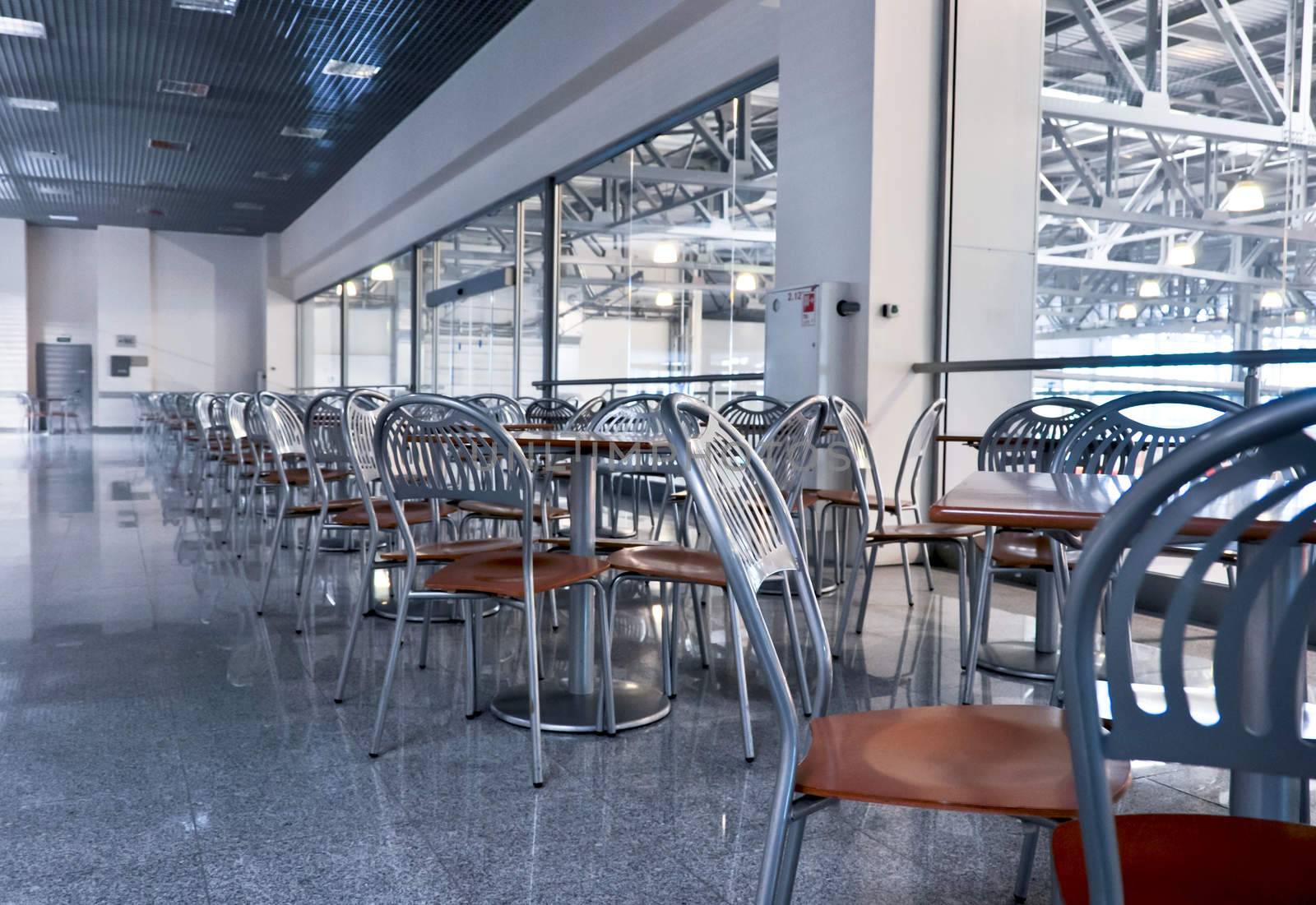 a lot of chairs and tables in fastfood cafe