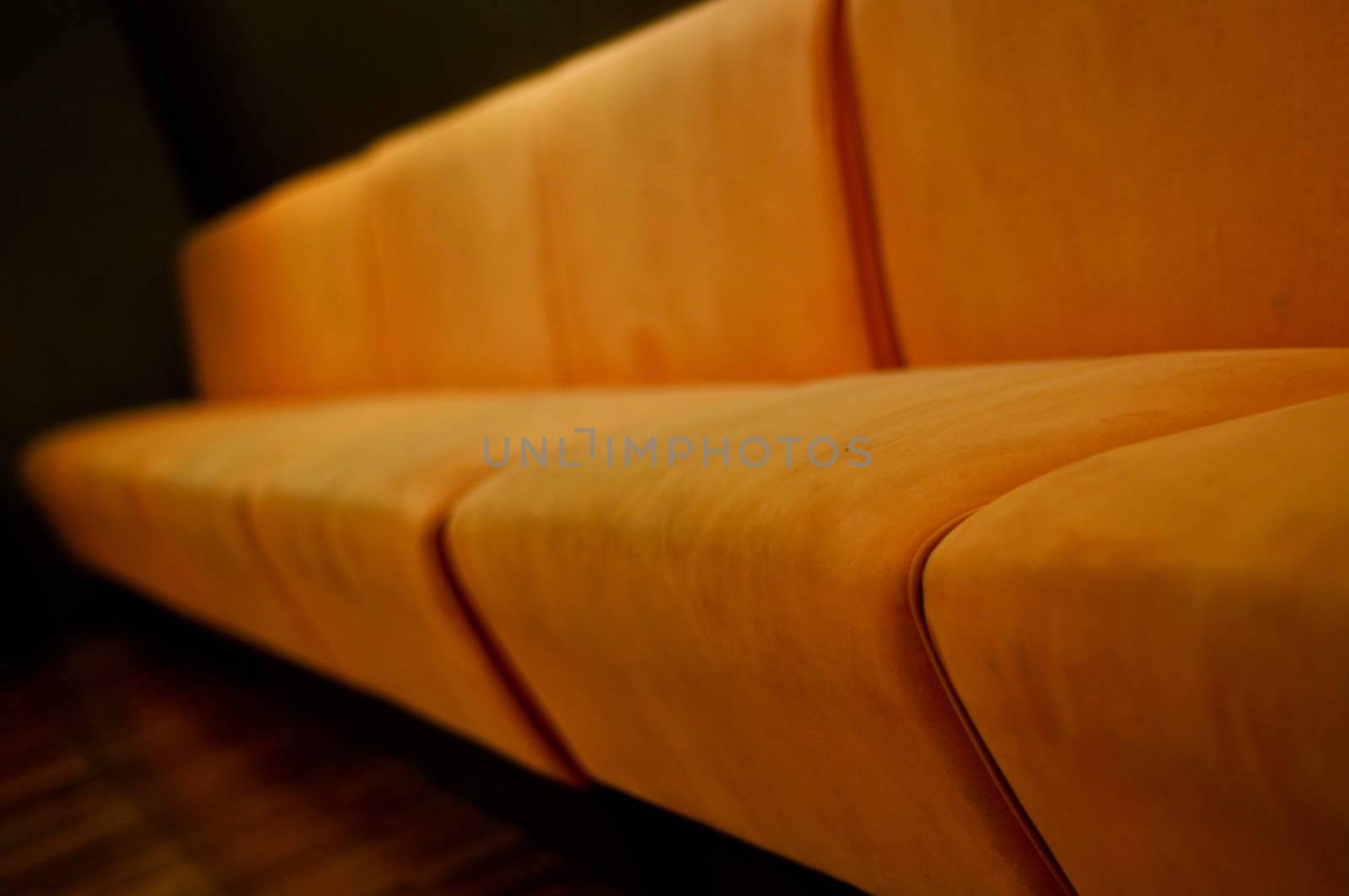 beige sofa in the room with dark green walls close up