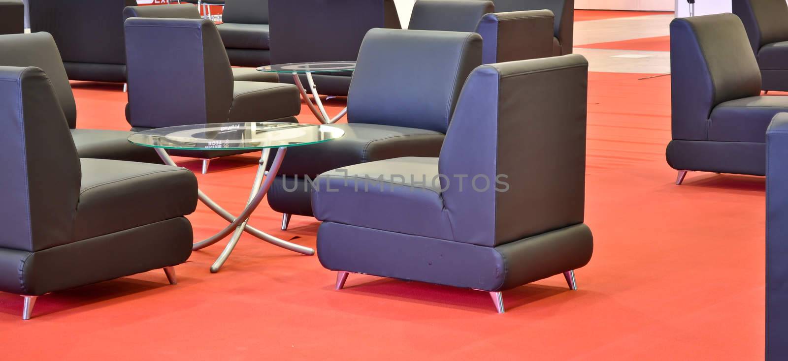 black armchairs on the red floor