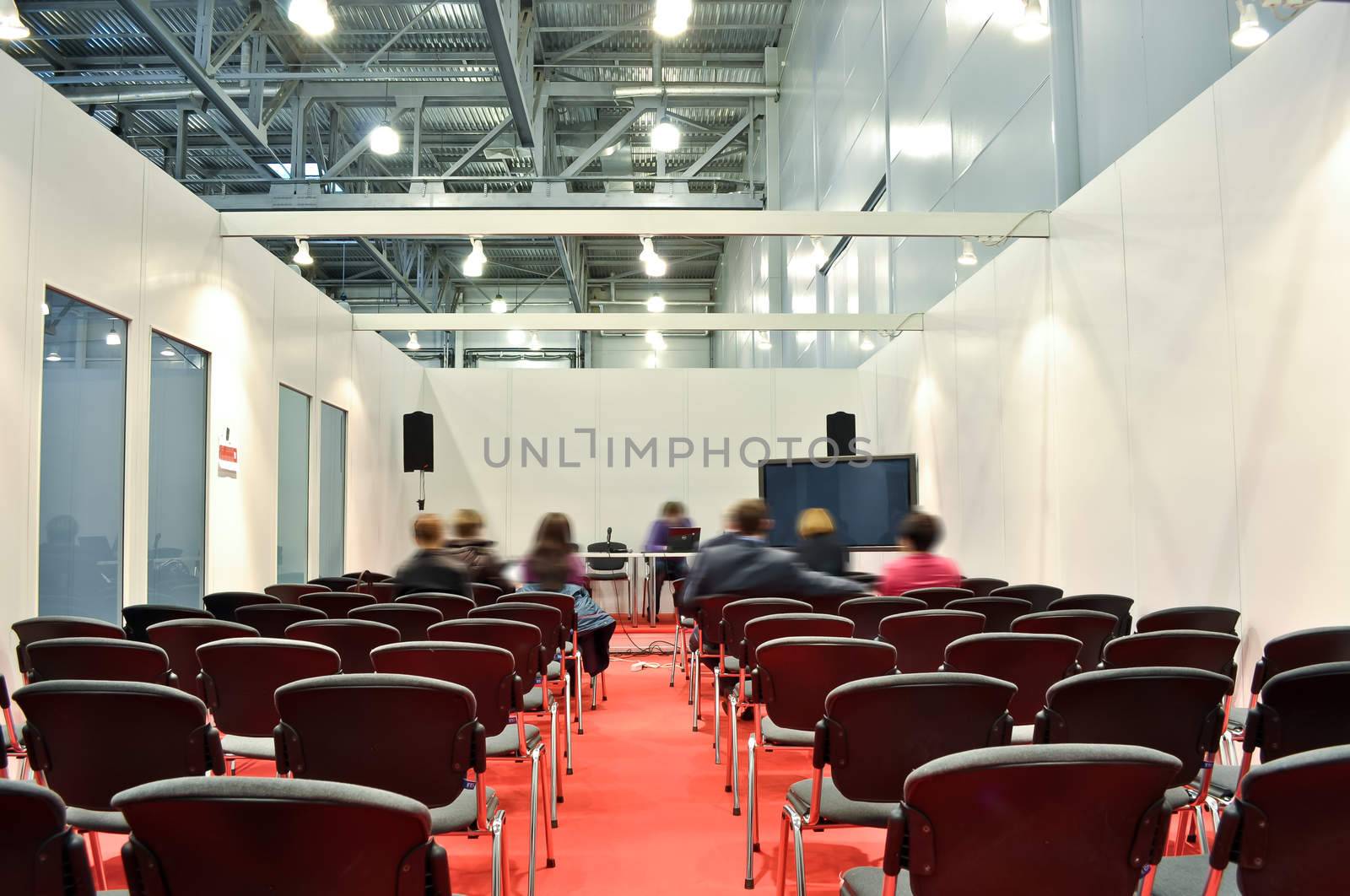 Grey chairs red floor in the Room for presentations by vlaru