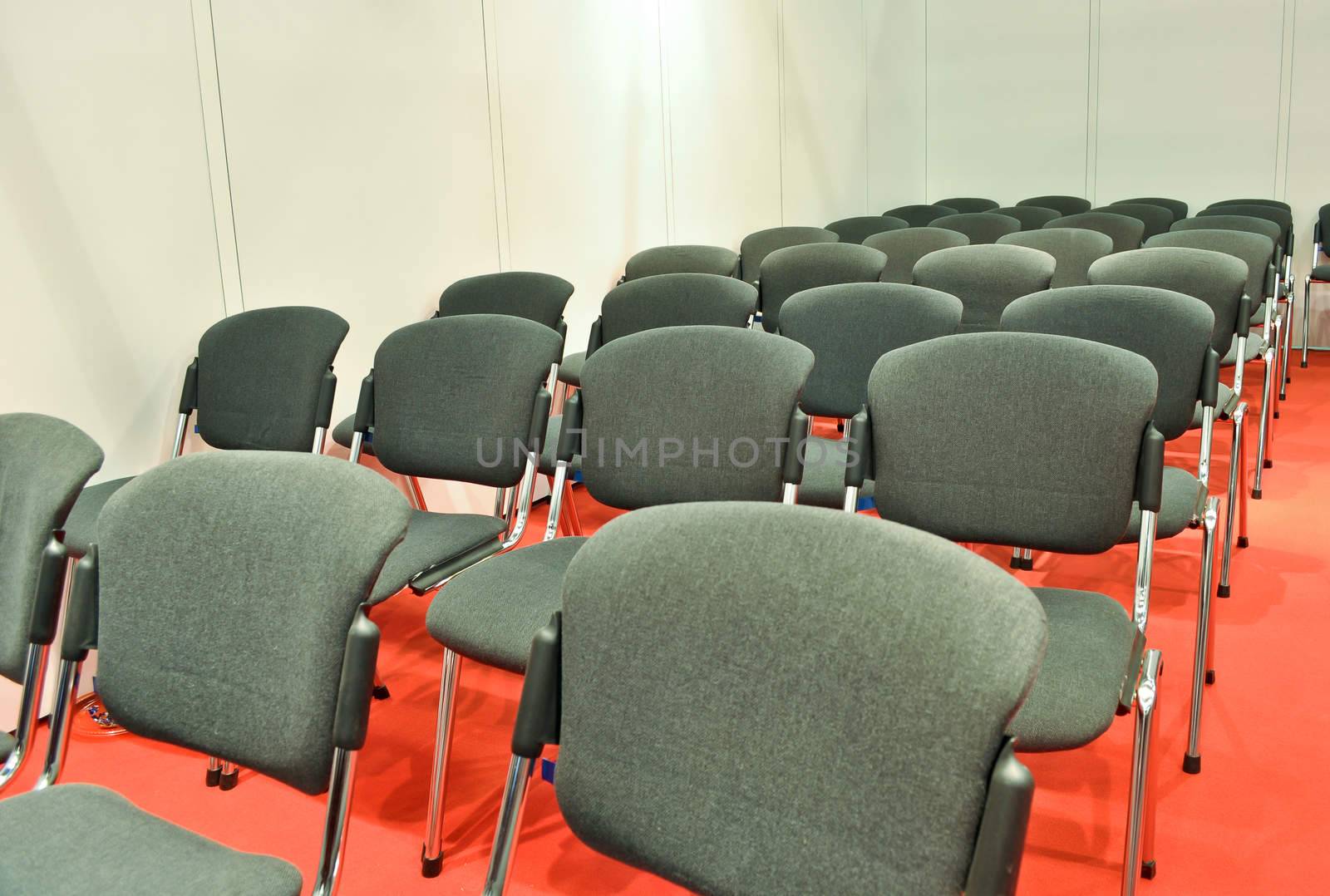 Grey chairs red floor in the Room for presentations by vlaru