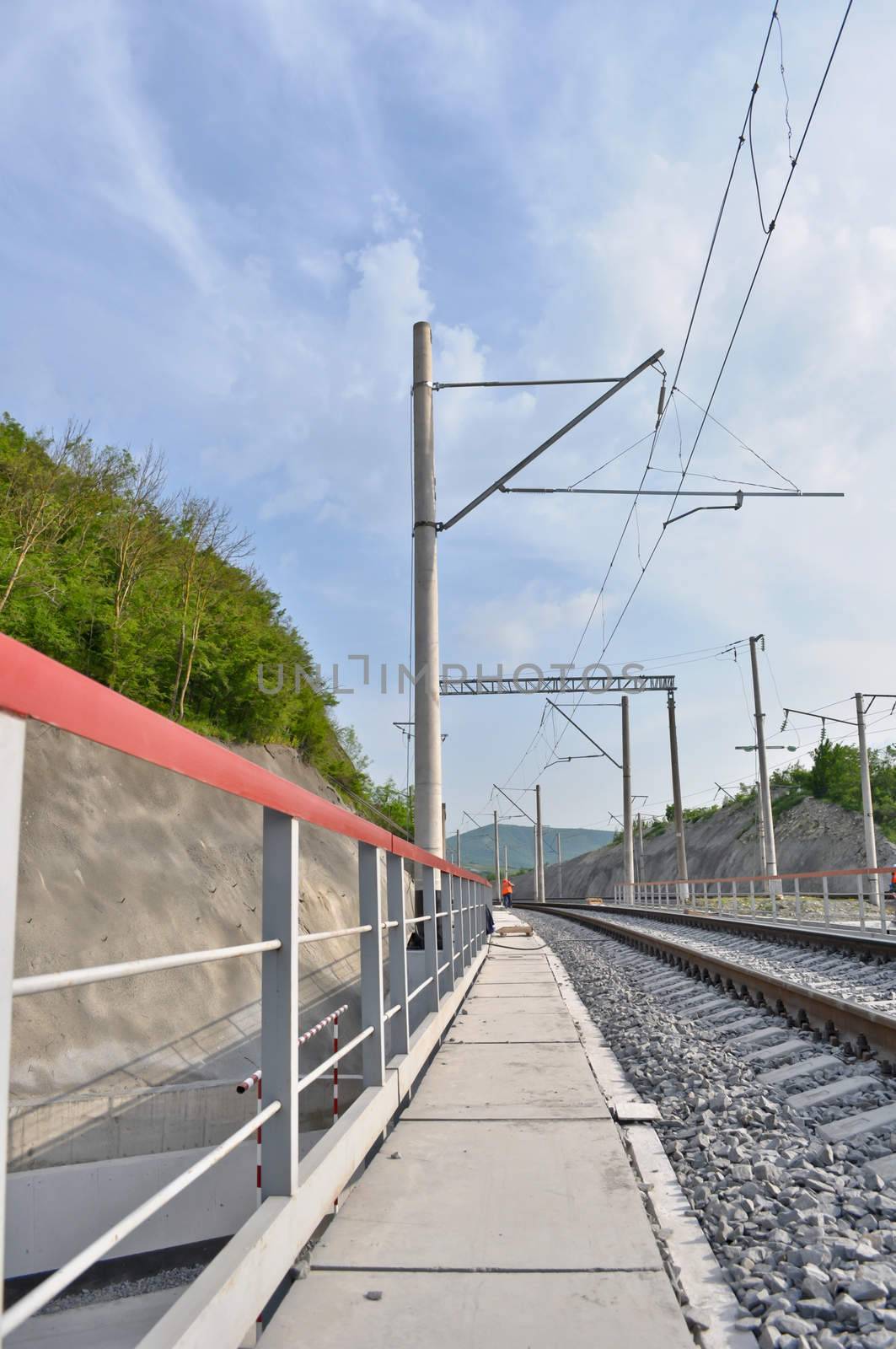 railroad track, embankment, and power poles