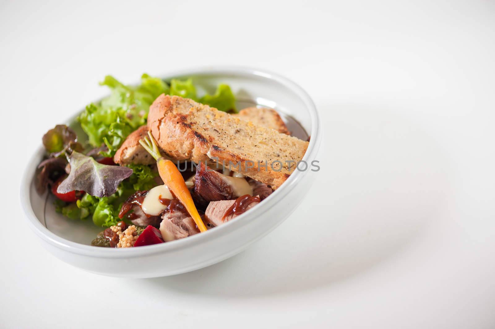 Modern style salad with garlic toast and grilled pork with barbecue sauce