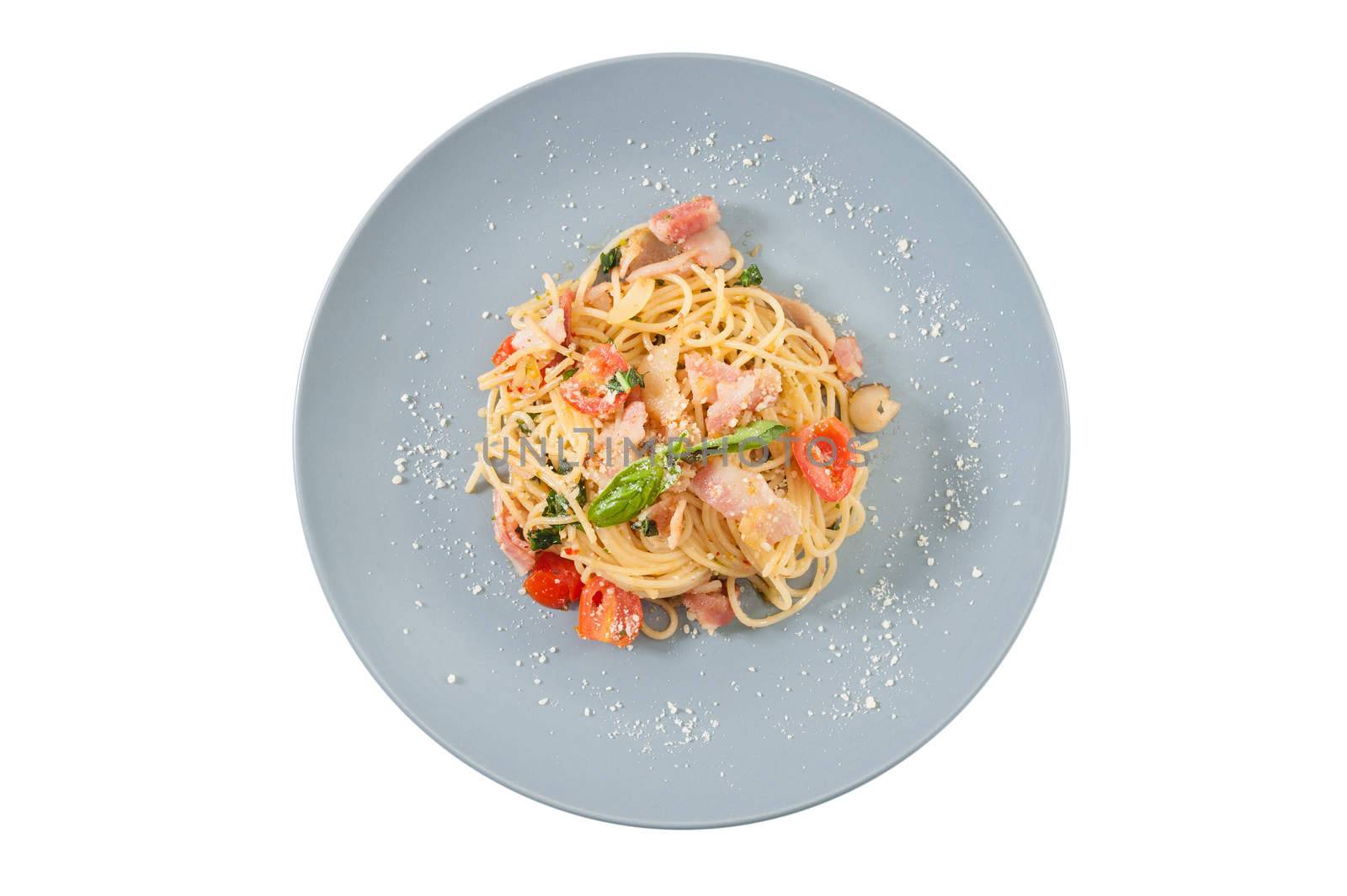 Pasta with bacon and tomato in grey ceramic dish isolated on white background with clipping path