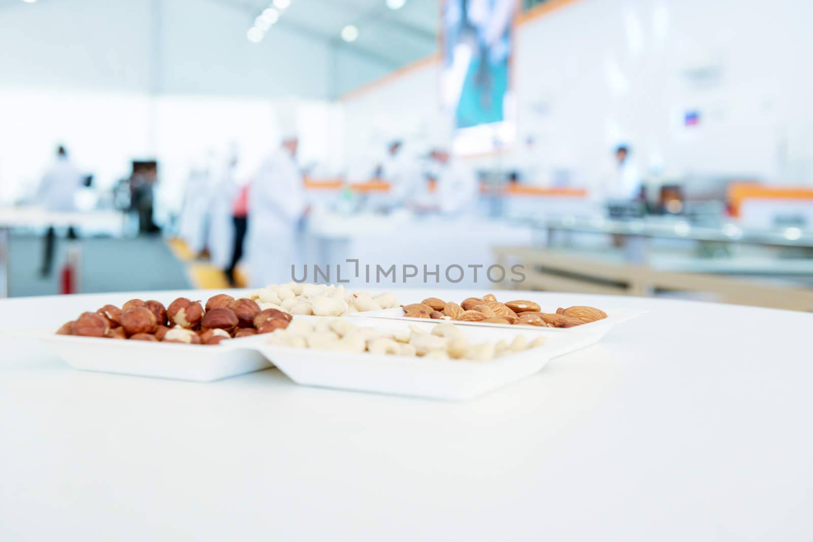 various nuts mix in square paper plates