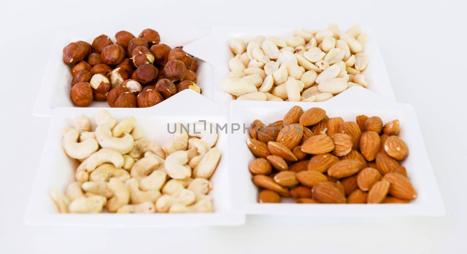 various nuts mix in square paper plates